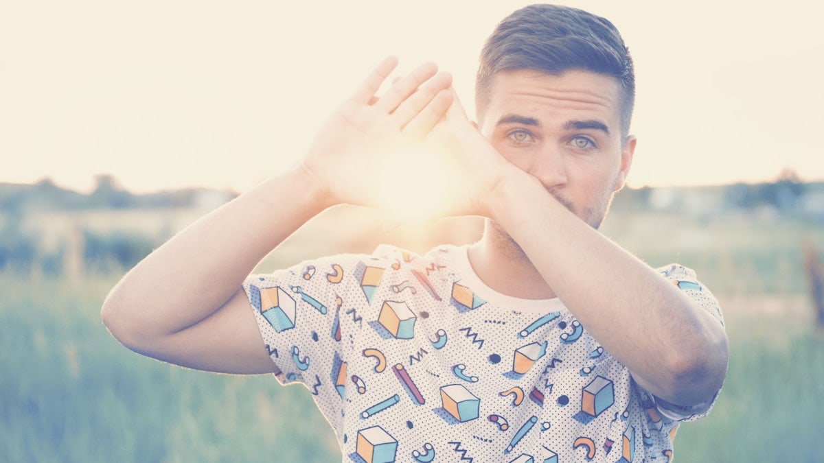 Man with green eyes holding the sun